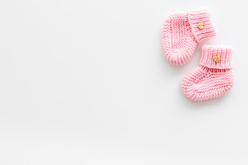 Cute baby booties for girl on white background top view copyspace