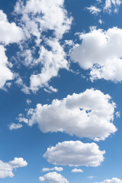 Sky Landscape with Soft White Clouds Against a Bright Blue Sky - Vertical