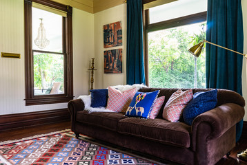 Eclectic decor, colorful, persian rug , boho, velvet, vintage, empty, natural light, wood trim