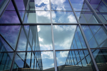 reflection image of sky and clouds in typical office building windows