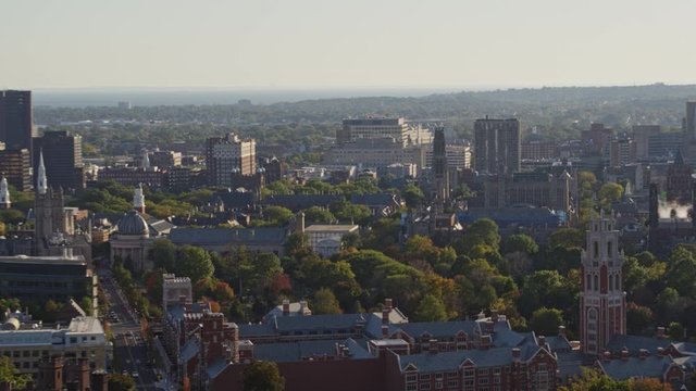 New Haven Connecticut Aerial v8 Low panning birdseye view of classic brick university campus buildings to water views - October 2017
