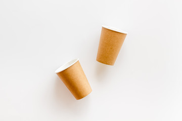 Empty paper cups for coffee to-go from cafe on white background top view mock up