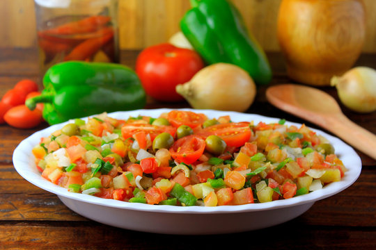 Vinagrete or Vinaigrette is a traditional Brazilian cuisine salad made with tomatoes, peppers, onions, vinegar, parsley and olives.