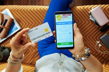 woman with credit card looking at checkout screen on website