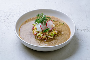 okroshka on kvass on white concrete table
