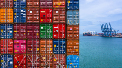 Container ship loading and unloading in deep sea port, Aerial top view of business logistic import and  export freight  transportation by container ship in open sea. - obrazy, fototapety, plakaty