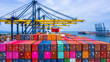 Container ship loading and unloading in deep sea port, Aerial top view of business logistic import...