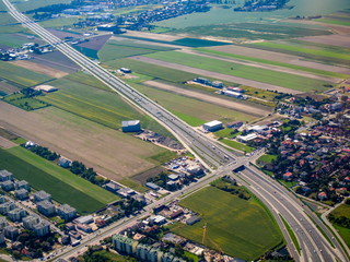 Aerial cityscape block of flats and higway and agriculture lands view