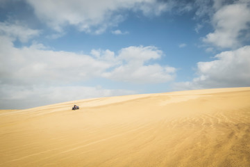 Quadbiking on sand dune, Stockton Sand Dunes, NSW, Australia