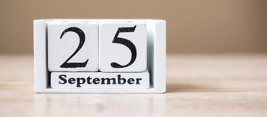 25 September of calendar wooden on table, World pharmacist day concept