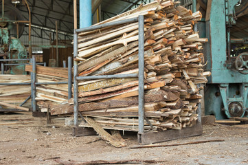 Stack of lumber woods in the steel container at wood factory or sawmill.