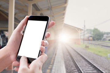 Close up Woman hand Using a Smart Phone with blank screen at cafe train station.