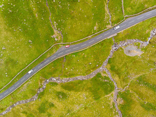 Lake District hills with waterfall and road with cars