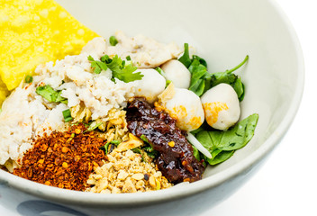 Thai style spicy instant noodles soup in bowl, Tom Yum with Thai herbs, Thai food, Noodle soup on white background.