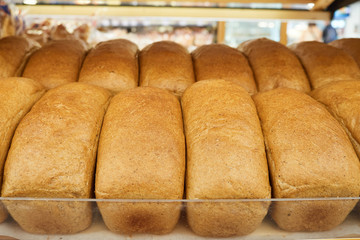 rows of fresh bread on supermarket shelves