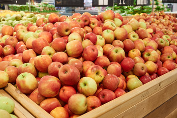 lots of red, fresh apples for sale at the supermarket