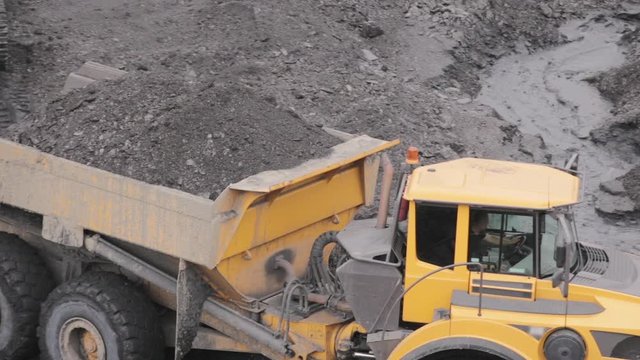A mining truck is carrying coal. Open pit coal mining