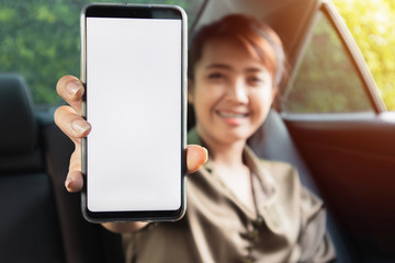 Hand holding smart phone in car.Technology concept.