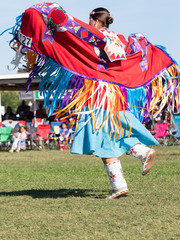 Young Native American Woman Dancing with Shawl Over Outstretched Arms