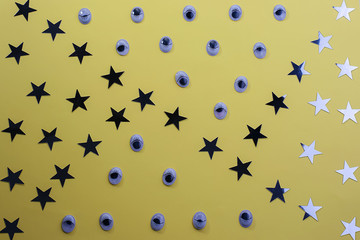 Decorative eyes on a yellow background background. Halloween concept Trick or treat. Creative concept for halloween. Flat lay, top view, copy space