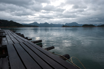 Brown wooden resort pathway on a cloudy lakeside