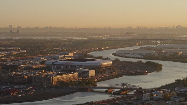 Newark New Jersey Aerial v22 Panoramic sunrise cityscape views near soccer arena with turnpike and freeway traffic and New York city skyline - October 2017