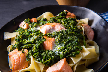 pappardelle pasta with creamed spinach and fried salmon