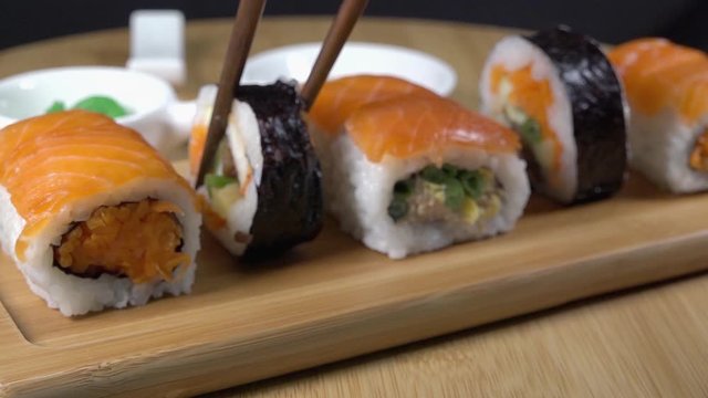Removing a Peice of Sushi From a Serving Board with Chopsticks