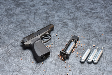 Pneumatic pistol on a grey background