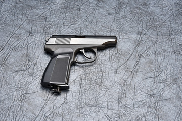 Pneumatic pistol on a grey background