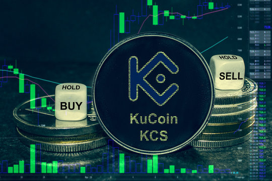 coin cryptocurrency KuCoin KCS  stack of coins and dice. Exchange chart to buy, sell, hold.