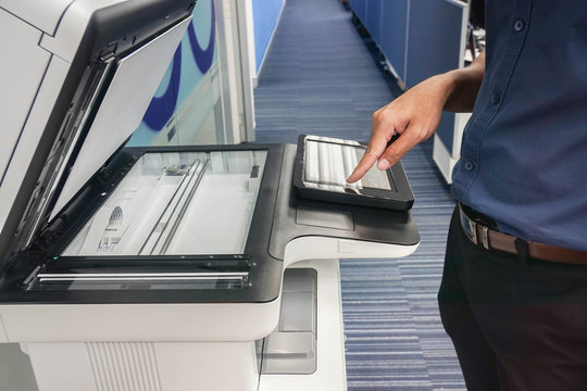 Close Up Businessman Set The Printer Function By Touch Screen