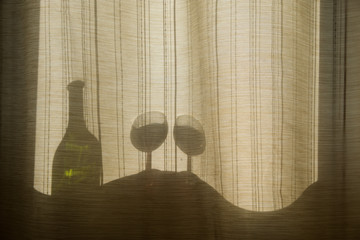 Collage on the theme of alcoholism, the curvature of space. Silhouettes of bottles and glasses through the curtains. Visions, delirium tremens, a drunk man. The sun's rays pass through the glass. Back