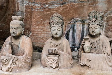 Statue of disciples or followers in front of giant Buddha at Dazu Rock Carvings at Mount Baoding or Baodingshan in Dazu, Chongqing, China. UNESCO World Heritage Site.