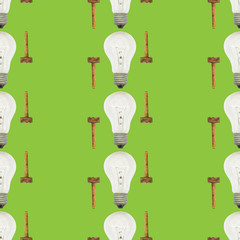 Creative bright seamless pattern of glass bulbs and hammer on a green background
