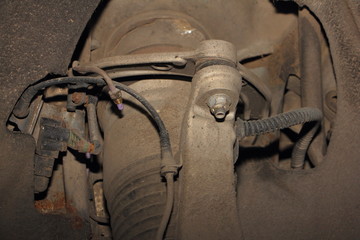 Close up upper arm of pneumatic suspension of the car on pneumatic cylinder with pipes background, air transmission repair