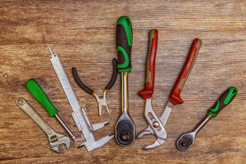 Set of different working tools on wooden background. Top view. Hand tool. Tools male workplace background texture dark wood. Copy space. Space for text.