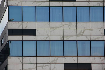 Wall of contemporary office center close up, windows of modern building