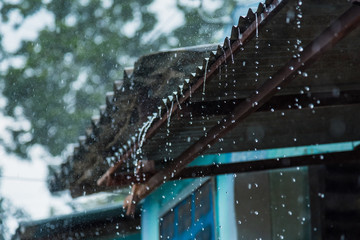 Rain storm with metal sheet roof,rainwater flows down the roof.