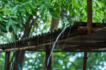 Rain storm with metal sheet roof,rainwater flows down the roof.