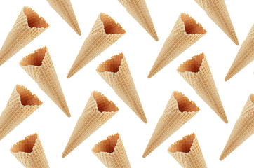 Empty waffle ice cream cones as decorative random summer food pattern isolated on white background.