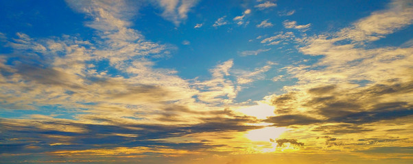 Beautiful Sunset in the sky with sky blue and orange light of the sun through the dark clouds in the sky, Orange and red dramatic colors - Image