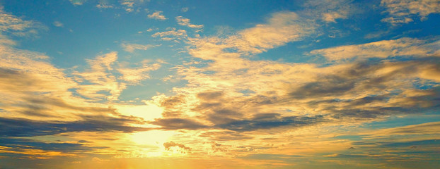 Beautiful Sunset in the sky with sky blue and orange light of the sun through the dark clouds in the sky, Orange and red dramatic colors - Image