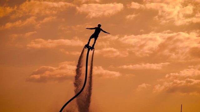Person propelling through air on flyboard