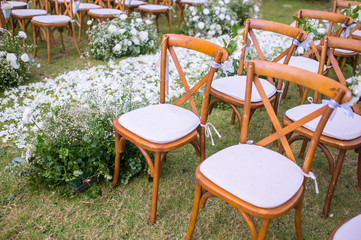Chair decorated with flowers in Wedding ceremony.