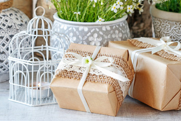 Beautifully wrapped gifts and flowers in the background