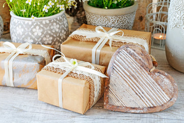 Beautifully wrapped gifts and flowers in the background