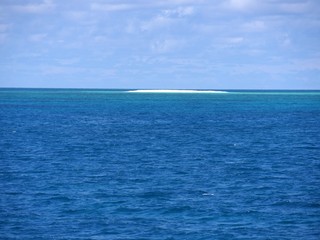 Stretch of sandbar in the middle of the ocean in the distance