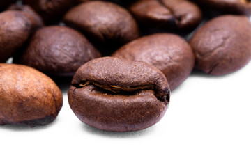 Close up of coffee bean on white background. Focus on middle bean