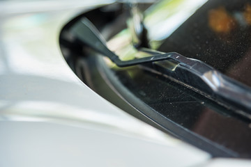 Car wiper of car parked on street sunlight background.